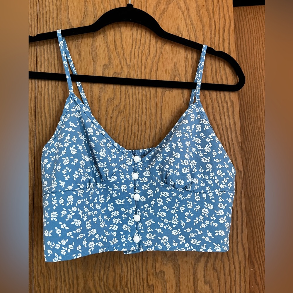 2 piece crop to and skirt. Light blue with white flowers. Size small.